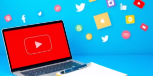 Laptop with YouTube logo and social media icons.