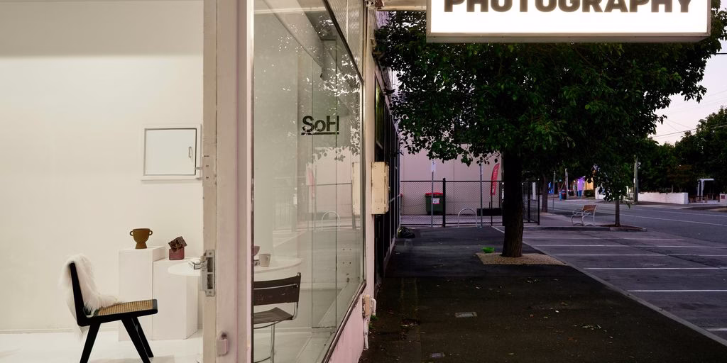 A photograph shop with a chair and a sign