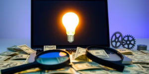 Laptop, money, magnifying glass, gears, lightbulb.